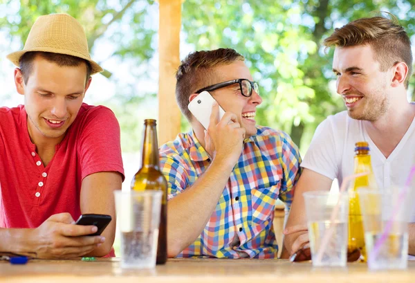 Three friends using smartphone — Stock Photo, Image