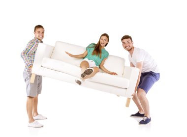Men lifting sofa with woman on it