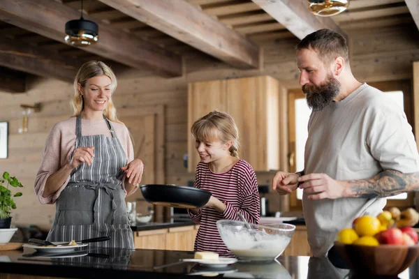 Family with small daughter cooking indoors, winter holiday in private apartment. — Stock Photo, Image