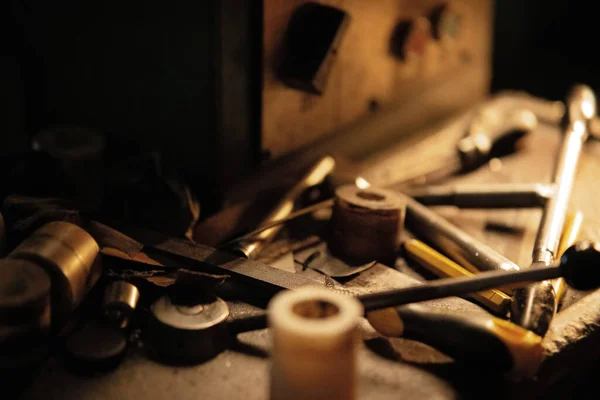 Close up of industrial tools indoors in metal workshop at night. — Stock Photo, Image