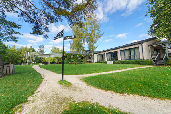 Outdoor hotel area with garden and navigational arrows