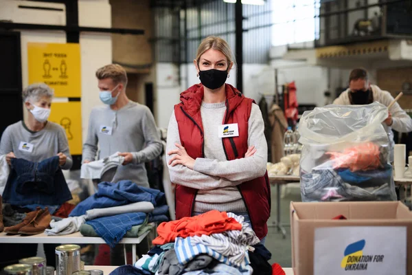 Volunteers collecting donations for the needs of Ukrainian migrants, humanitarian aid concept.