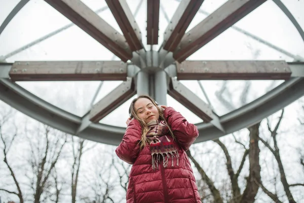 Down sendromlu mutlu genç bir kadın kışın kasabada müzik dinliyor. — Stok fotoğraf