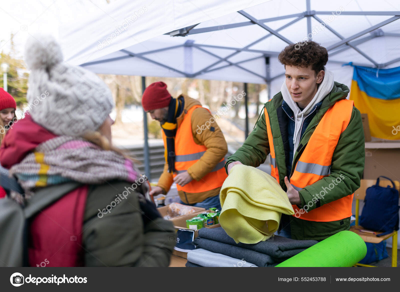 Volunteers distributing blankets and other donations to refugees on the