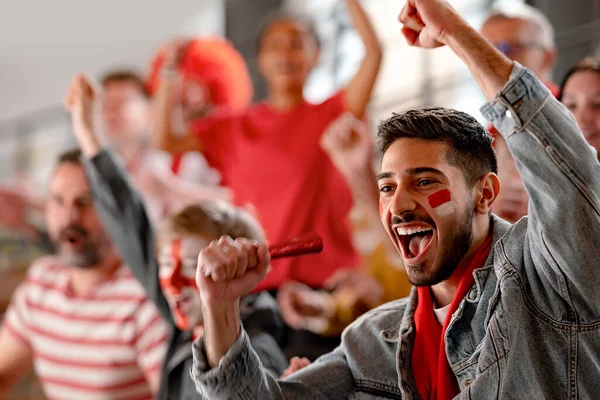 Excited football fans supproting Austrian national team in live soccer match at stadium. — Stock Photo, Image