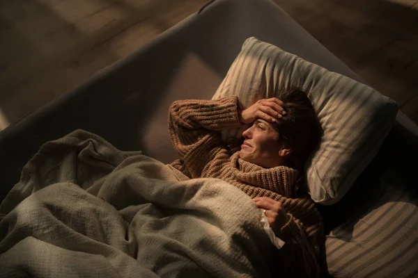Mujer triste que sufre de depresión covid acostado en la cama en la noche. —  Fotos de Stock