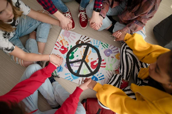 Top view of students praying for peace in world at school. — Stock Photo, Image