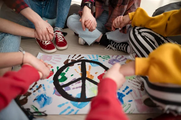 Cut out of students praying for peace in world at school. — Stock Photo, Image