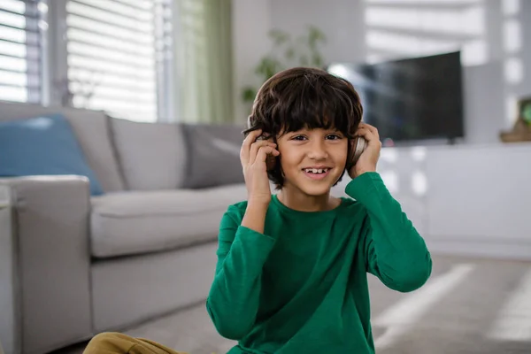 Feliz chico multirracial con auriculares escuchando música en casa. — Foto de Stock
