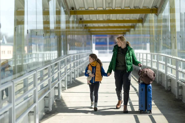 Imigran Ukraina ibu dengan anak dengan bagasi berjalan di stasiun kereta api, konsep perang Ukraina. — Stok Foto