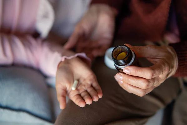 Close-up of grnadmothers hand giving medicine to her grandchild. — Foto Stock
