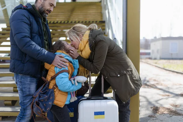 Ukrajinská uprchlická rodina se zavazadly na nádraží společně, ukrajinská válečná koncepce. — Stock fotografie
