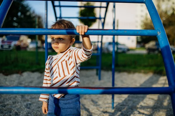 A little boy playing on outdoor playground. — Foto Stock