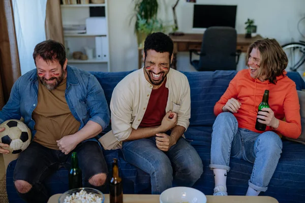 Happy German football fans friends watching football at home and eating popcorn. — Stock Photo, Image