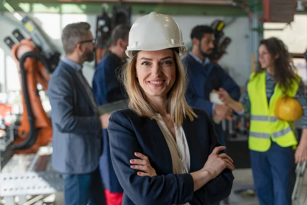 Portrait of female chief engineer in modern industrial factory looking at camera. — Stock Fotó