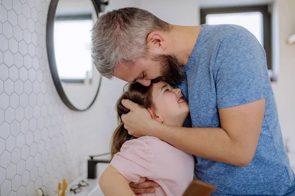 Father kissing his little daughter in bathroom. — Stok fotoğraf