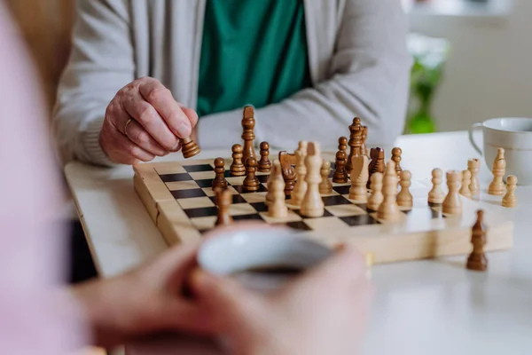 Close-up of senior man playing chess with his daughter at home. — Stok Foto