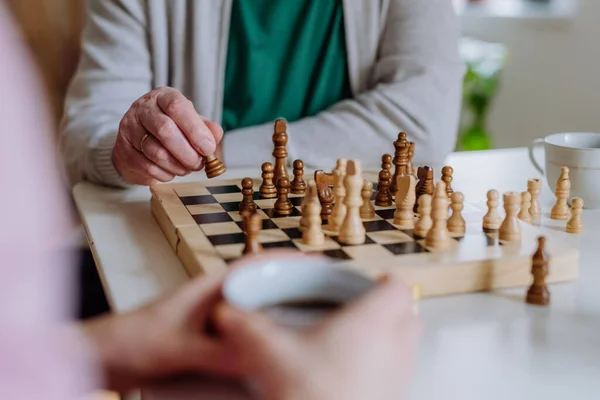 Close-up of senior man playing chess with his daughter at home. — ストック写真