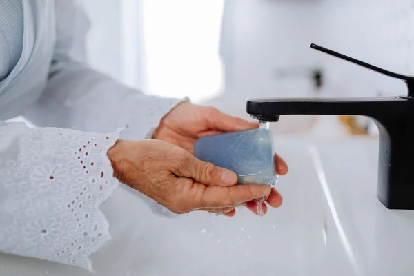 Close-up of woman washing hands with natural lavender soap, ecological sustainable lifestyle. — Foto de Stock