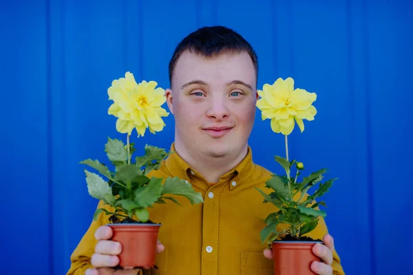 Happy Young Man Syndrome Looking Camera Holding Pot Flowers Blue — Stock Photo, Image