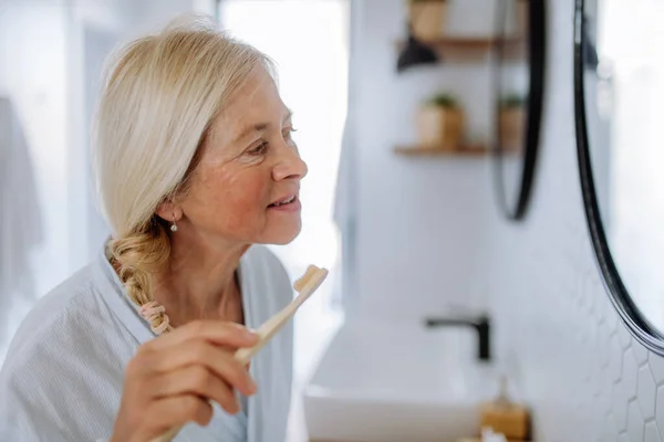 Eautiful Senior Woman Bathrobe Brushing Teeth Eco Wooden Toothbrush Inbathroom — Stockfoto
