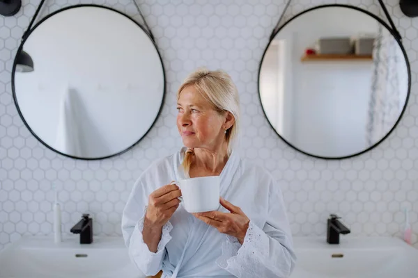 Beautiful Senior Woman Bathrobe Drinking Tea Bathroom Relax Wellness Concept — Foto de Stock