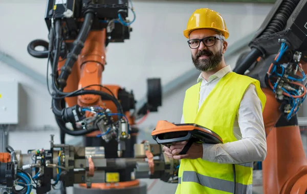An automation engineer holding scanner in industrial in factory.