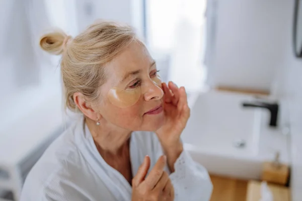 Beautiful Senior Woman Bathrobe Applying Eye Patches Puffiness While Looking — Φωτογραφία Αρχείου