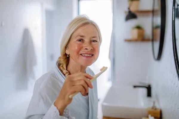 Eautiful Senior Woman Bathrobe Brushing Teeth Eco Wooden Toothbrush Inbathroom — Stock Photo, Image