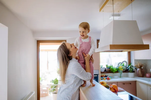 Young Mother Holding Her Little Daughter Walking Kitchen Counter Home — Stock Photo, Image