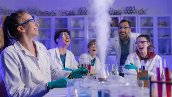 Science students doing a chemical experiment in the laboratory at university.