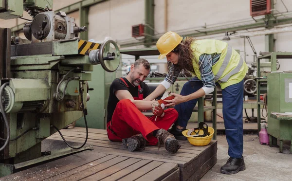 Woman Helping Her Colleague Accident Factory First Aid Support Workplace — Stock Photo, Image