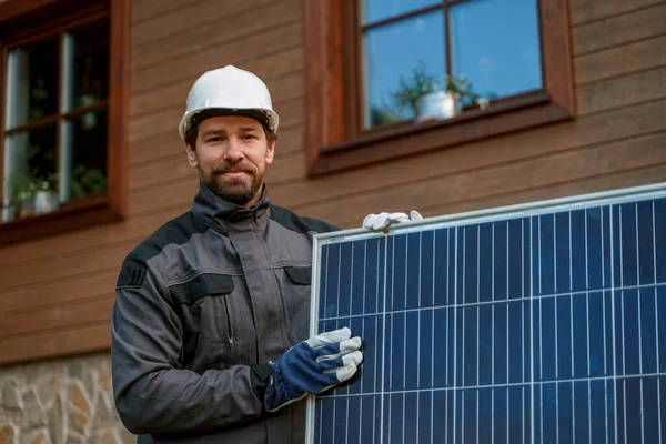 Smiling Handyman Solar Installer Carrying Solar Module While Installing Solar — Stockfoto