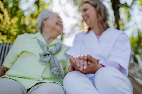 Low Angle View Caregiver Consoling Senior Woman Touching Her Hand — Stockfoto