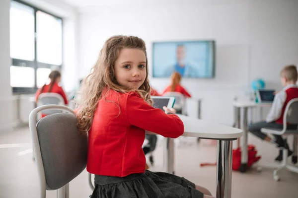 Happy Schoolgirl Wearing School Uniform Sitting Class Smiling Camera — Fotografia de Stock