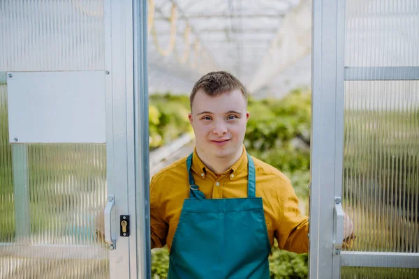 Jovem Funcionário Com Síndrome Trabalhando Centro Jardinagem Olhando Para Câmera — Fotografia de Stock