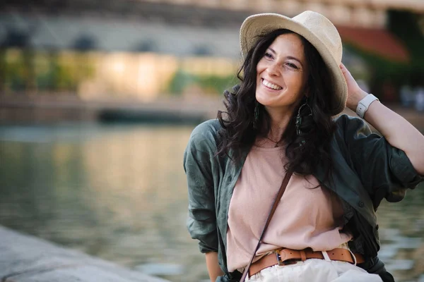 A woman candid portrait from park. Young urban female tourist smiling .