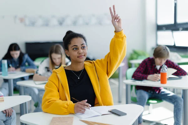 High School Students Paying Attention Class Sitting Desks Raising Hands — Stockfoto