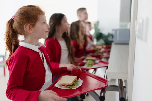 Happy Schoolchildren Standing Queue Trays Receiving Lunch School Canteen — Fotografia de Stock
