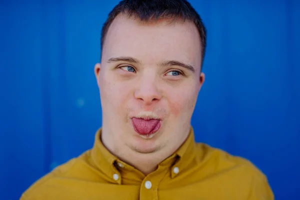 Close Happy Young Man Syndrome Grimacing Sticking Out Tongue Blue — Fotografia de Stock