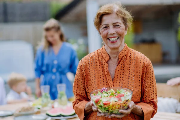 Happy Senior Woman Serving Salad Multi Generation Garden Party Summer — Stock Photo, Image