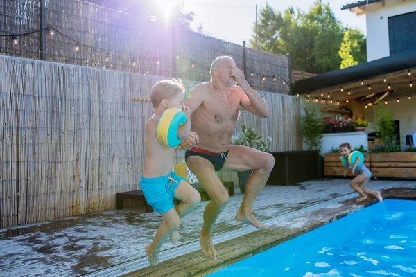 Grandfather His Granson Having Fun Together Jumping Swimming Pool Backyard — Stock Fotó