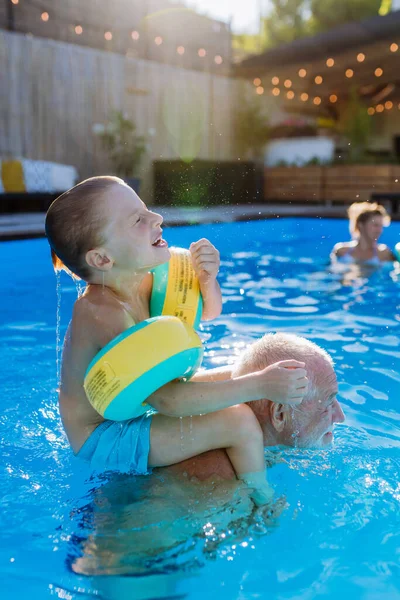 Grandfather His Granson Having Fun Together Playing Swimming Pool Backyard — Stok fotoğraf