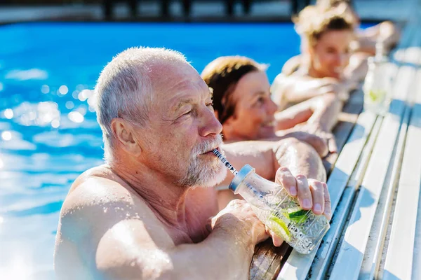 Senior Man Enjoying Cold Drink Standing Swimming Pool His Family — Stock fotografie