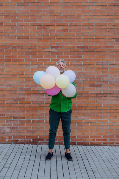 Fun Portrait Happy Energetic Mature Man Holding Balloons Street Hiding — Zdjęcie stockowe