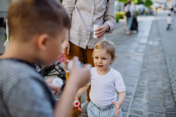 Little Boy Blowing Bubbles His Little Sister City Street Summer —  Fotos de Stock
