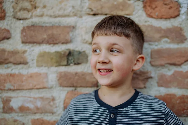 Little Boy Standing Brick Wall Making Funny Faces Street Summer — Stock Photo, Image