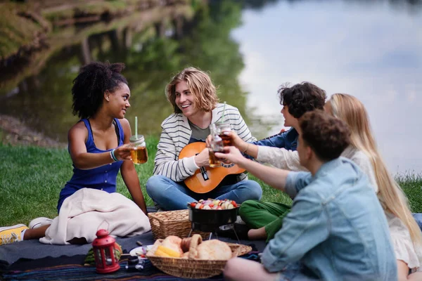 Group Young Friends Having Fun Picnic Lake Sitting Blanket Toasting — Photo