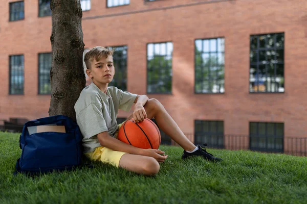 Cheerful Caucasian Boy Sitting Public City Park Baskaetball Ball Looking — 스톡 사진