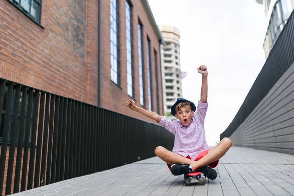 Cheerful Caucasian Boy Sitting Skateboard Going Hill Looking Camera — Φωτογραφία Αρχείου